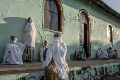 Tigrayan women who fled the conflict in Ethiopia's Tigray region, pray during Sunday Mass at a church near Umm Rakouba refugee camp in Qadarif, eastern Sudan, on November 29, 2020