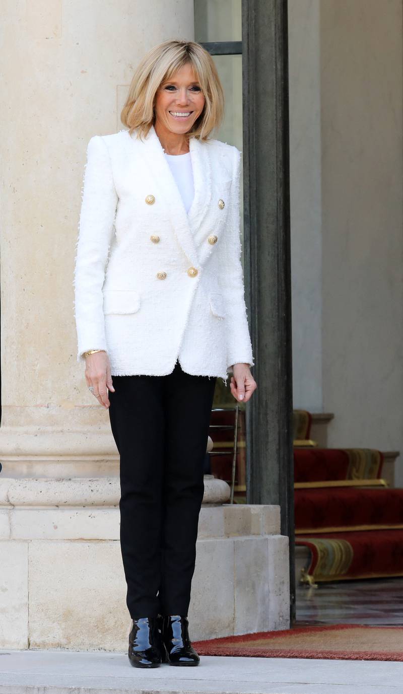 Brigitte, wearing a white blazer and trousers, on February 21, 2018. AFP