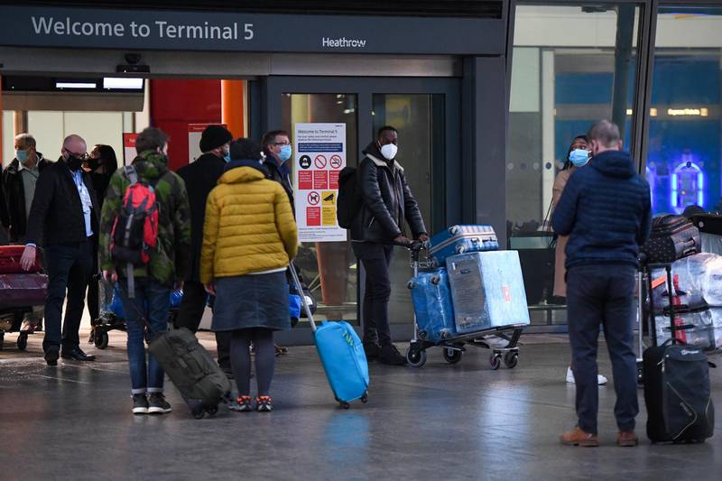 Passengers are guided towards a coach after arriving at Heathrow Airport in London. Some passengers traveling to the UK will face tougher quarantine measures, including enforced stays in hotels. Bloomberg
