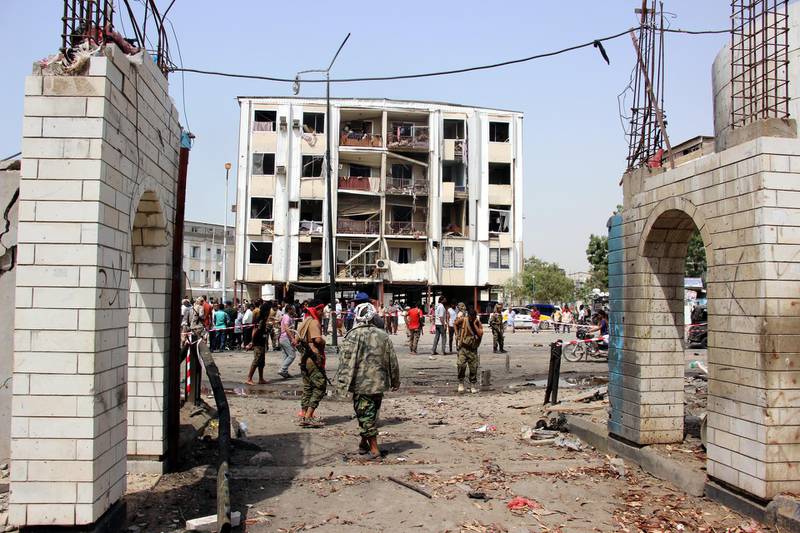 Yemeni soldiers inspect the site of a car bomb attack.  EPA