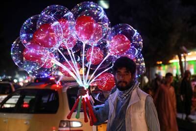 A vendor sells balloons on a road in Kabul. EPA