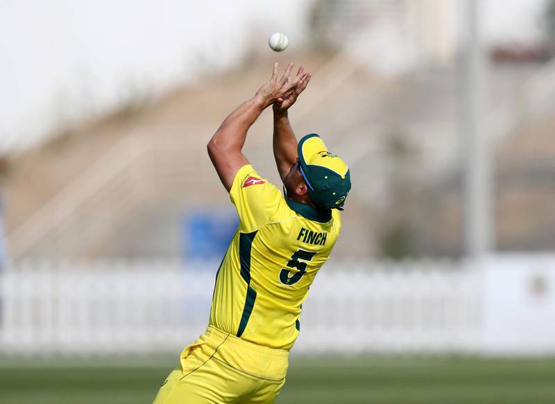 Abu Dhabi, United Arab Emirates - October 22, 2018: Aaron Finch of Australia catches out Rameez Shahzad of the UAE in the match between the UAE and Australia in a T20 international. Monday, October 22nd, 2018 at Zayed cricket stadium oval, Abu Dhabi. Chris Whiteoak / The National