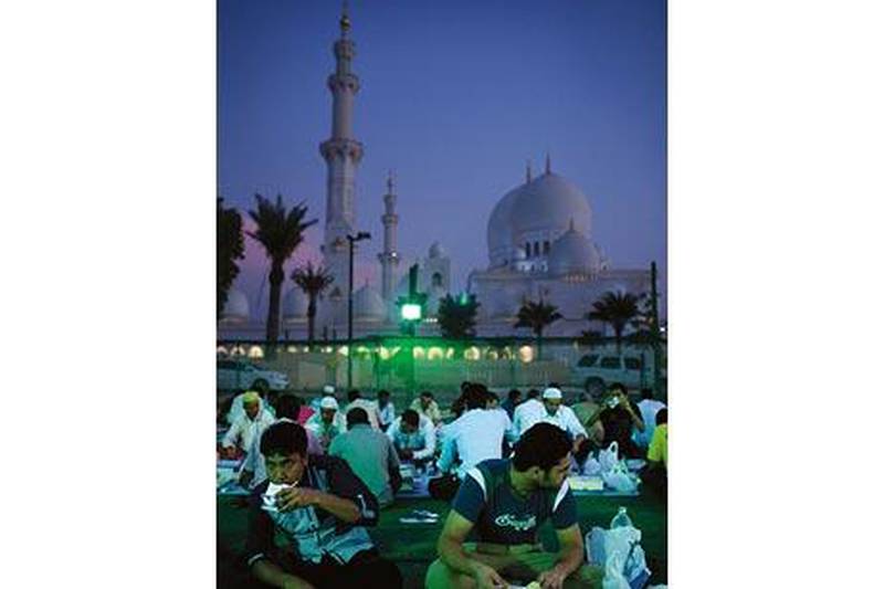 Men break their fast this month during iftar at Abu Dhabi's Sheikh Zayed Mosque.