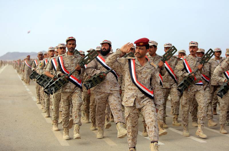 Fighters loyal to Yemen's Saudi-backed government take part in a military parade marking the 56th anniversary of the 1962 revolution that established the Yemeni republic, in the country's northeastern province of Marib.