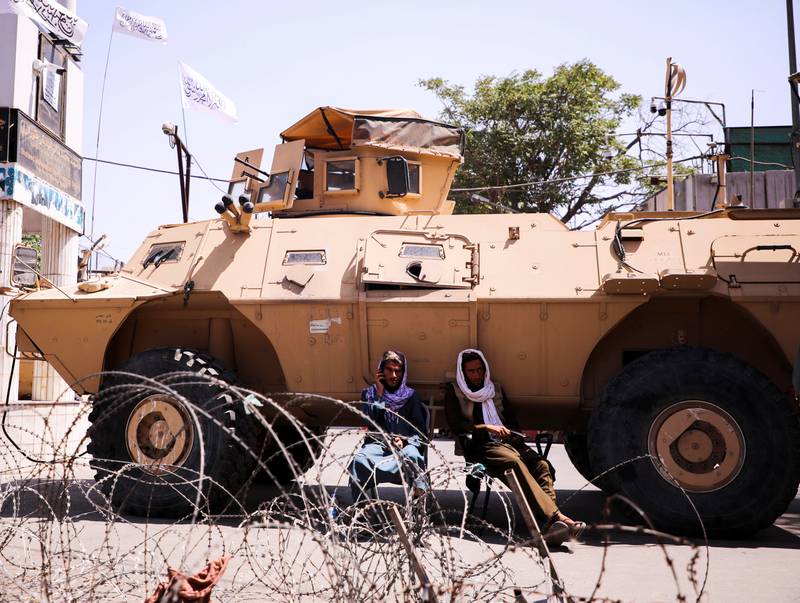 Taliban forces use an armoured vehicle to block the road near the presidential place in Kabul, Afghanistan. Reuters