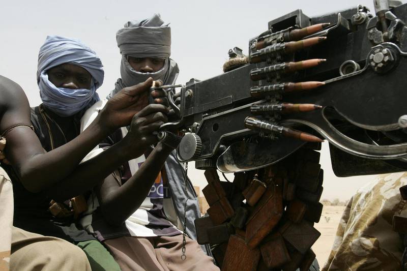 A picture taken 20 May 2006 shows rebels from the Sudan Liberation Movement (SLM) in Tina, a small village next to Tawila, a town located 70 kms west of al-Fasher, capital of Northern Darfur. This branch of the SLM loyal to Abdulwaheed Mohamed Nur didn't sign the peace deal with Karthoum. They demand more rights, but have been threatened by the UN security council of sanctions if they don't agree to the peace before May 31. AFP PHOTO/RAMZI HAIDAR (Photo by RAMZI HAIDAR / AFP)