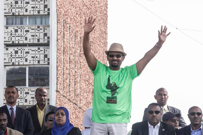Ethiopia Prime Minister Abiy Ahmed waves to the crowd during a rally on Meskel Square in Addis Ababa on June 23, 2018. A blast at a rally in Ethiopia's capital today in support of new Prime Minister Abiy Ahmed killed several people, state media quoted the premier as saying. / AFP / YONAS TADESE

