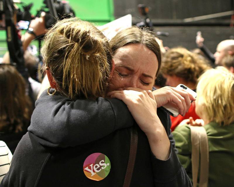 People from the"Yes" campaign react as the results of the votes begin to come in, after the Irish referendum on the 8th Amendment of the Irish Constitution at the RDS count centre, in Dublin, Ireland, Saturday May 26, 2018. A leading anti-abortion group says Irelandâ€™s historic abortion referendum has resulted in a "tragedy of historic proportions" in a statement that all but admits defeat, as two exit polls predict an overwhelming victory for those seeking to overturn the countryâ€™s strict ban on terminations. (AP Photo/Peter Morrison)