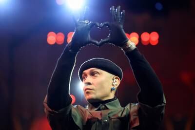 Band member Taboo makes a heart-shaped gesture to his fans.