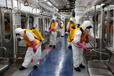 Employees from a disinfection service company sanitise a subway car depot amid coronavirus fears in Seoul, South Korea. Reuters