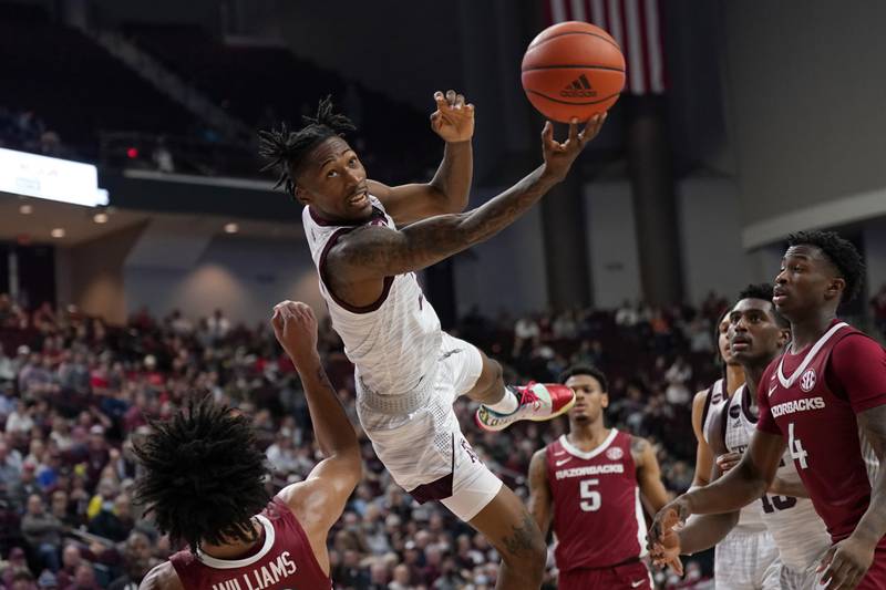Texas A&M guard Quenton Jackson tries to make a basket after being fouled by Arkansas forward Jaylin Williams during the second half of an NCAA college basketball game in College Station, Texas. AP