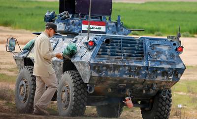 Iranian Revolutionary Guard Commander Qassem Soleimani walks near an armoured vehicle at the frontline during offensive operations against Islamic State militants in the town of Tal Ksaiba in Salahuddin province March 8, 2015. Picture taken March 8, 2015.   REUTERS/Stringer (IRAQ - Tags: CIVIL UNREST CONFLICT POLITICS)