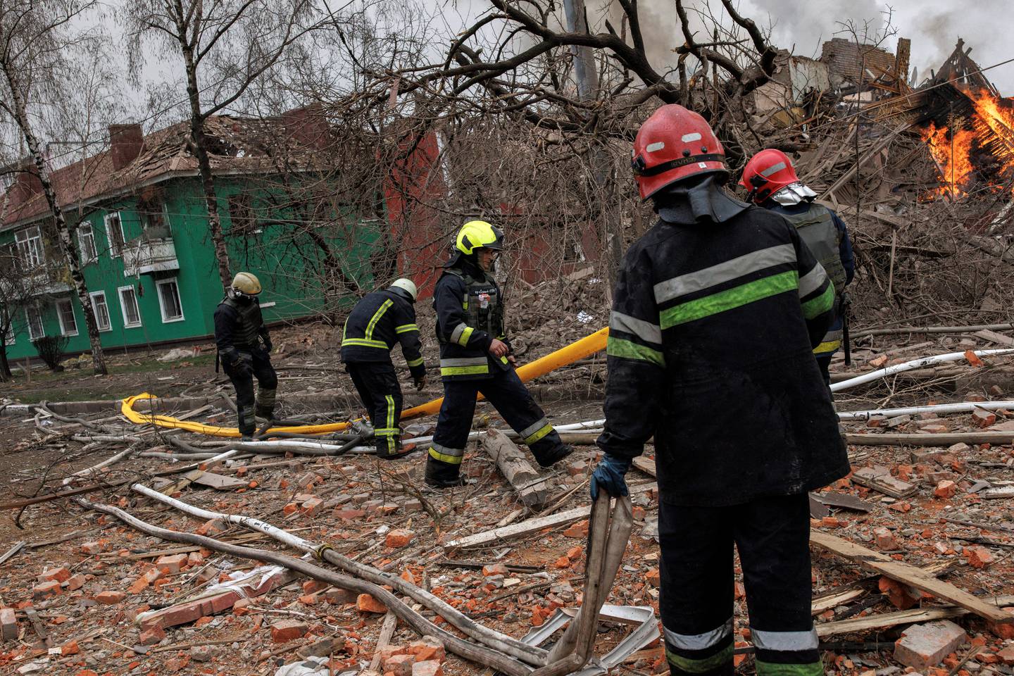 Firefighters at a burning building after a missile attack near the Kharkiv International Airport. Reuters