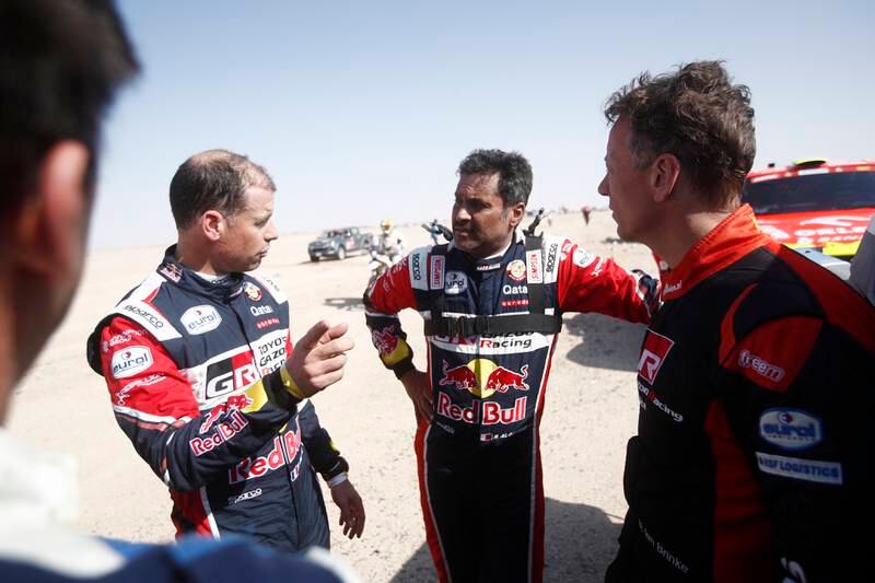 Qatari participant Al-Attiya Nasser (C) talks to his French co-driver Matthieu Baumel (L) about the difficulties of stage 7. EPA