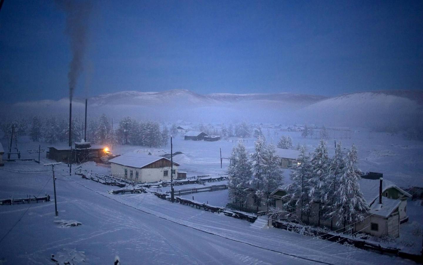 Mandatory Credit: Photo by Amos Chapple/Shutterstock (2087439d)
Oymakon village at dawn with a plume of smoke rising from the heating plant
Village of Oymyakon, which is considered to be the coldest permanently inhabited settlement in the world, Russia - Jan 2013
*Full story: http://www.rexfeatures.com/nanolink/jpod 
If you thought it was cold where you are at the moment then a visit to the Russian village of Oymyakon and city of Yatutsk might just change your mind. With the average temperature for January a blisteringly cold -50c it is no wonder Oymyakon is the coldest permanently inhabited settlement in the world. Oymyakon lies a two day drive from the city of Yakutsk, the regional capital, which has the coldest winter temperatures for any city in the world. Ironically, Oymyakon actually means "non-freezing water" due to a nearby hot spring. The village was originally a stopover for reindeer herders who would water their flocks from the thermal spring. Known as the "Pole of Cold", the coldest ever temperature recorded in Oymyakon was a mind numbing -71.2c. This is the lowest recorded temperature for any permanently inhabited location on Earth and the lowest temperature recorded in the Northern Hemisphere.