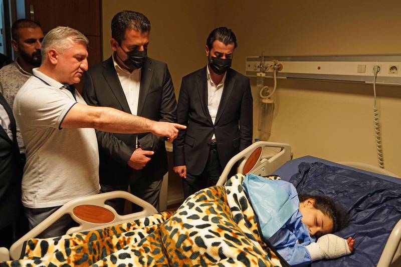 Saman Barzanji, centre, Health Minister in the Kurdistan Regional Government, visits the wounded at a hospital in Zakho. AFP
