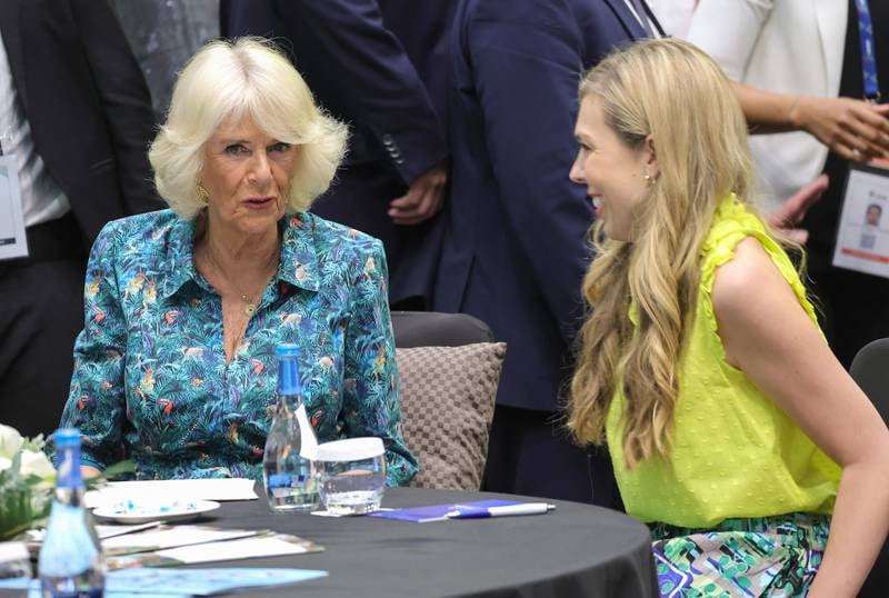 Camilla, Duchess of Cornwall and Carrie Johnson, wife of Britain's Prime Minister Boris Johnson, speak as they attend a Violence Against Women and Girls event at the Kigali Convention Centre. Getty Images