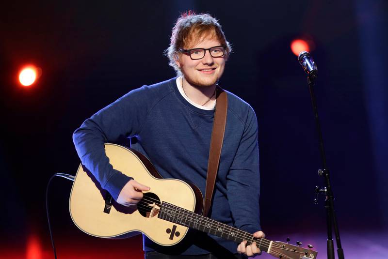 FILE - In this file photo dated Sunday, March 12, 2017, British singer Ed Sheeran performs during the Italian State RAI TV program "Che Tempo che Fa", in Milan, Italy.  Sheeran has told fans via Instagram that he's had a bicycle injury and posted a photo of his arm in a cast, advising fans he may have to change some concert dates with a series of shows in Asia scheduled to start on Oct. 22. (AP Photo/Antonio Calanni, FILE)