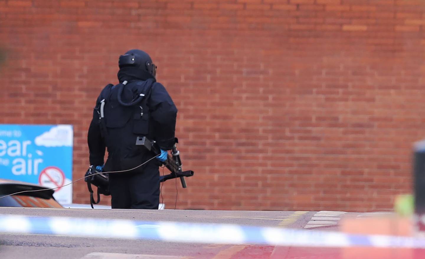 A member of the bomb disposal unit wearing protective equipment at St James's Hospital in Leeds. PA