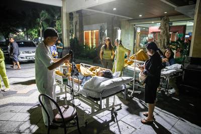 Hospital patients are moved outside of the hospital building after an earthquake was felt in Denpasar, Bali. EPA