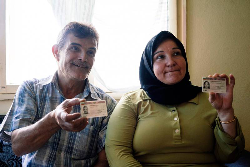 Syrian refugees Fahim Jaber (L) and his wife Fatima Batayi show their Bulgarian ID cards on July 10, 2017 at a place they rent in the small town of Elin Pelin, outside Sofia.
Syrian refugee Fahim Jaber hoped for a better life in Europe. But like hundreds of others, he is stuck in Bulgaria, the EU's poorest country, safe but feeling unwelcome and abandoned. Since 2013, almost 60,000 migrants have applied for asylum in Bulgaria, taking the land route out of Syria into Europe via Turkey and then over the border into Bulgaria. / AFP PHOTO / Dimitar DILKOFF