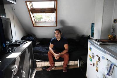 Ivan Lopez poses at his flat, which measures ess than 7 square metres, in  the 5th district of Paris, on September 14, 2016.  Thomas Samson / AFP 

