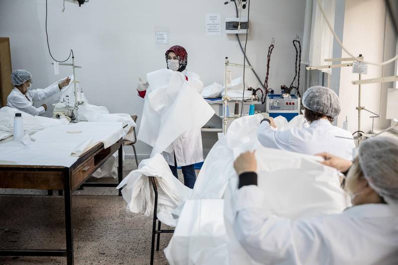 Teachers volunteer their time to help make bodysuits amid the Covid-19 outbreak at a Vocational and Technical Anatolian School in Istanbul, Turkey. Getty Images