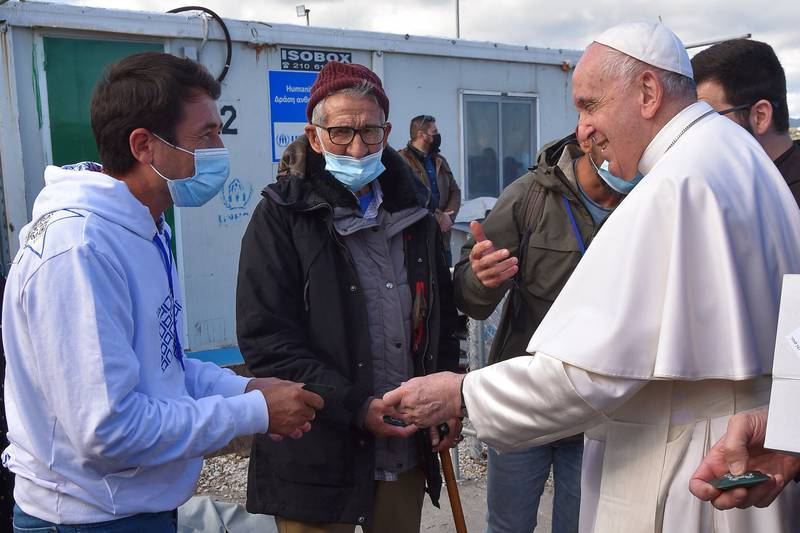 Pope Francis meets migrants during his visit to an identification centre on the Greek island of Lesbos. AFP