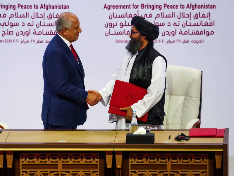 FILE PHOTO: Mullah Abdul Ghani Baradar, the leader of the Taliban delegation, and Zalmay Khalilzad, U.S. envoy for peace in Afghanistan, shake hands after signing an agreement at a ceremony between members of Afghanistan's Taliban and the U.S. in Doha, Qatar February 29, 2020. REUTERS/Ibraheem al Omari/File Photo