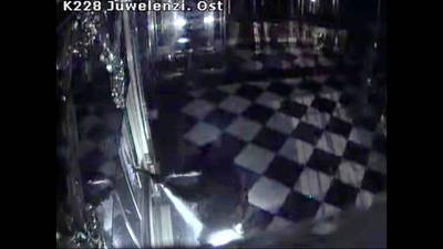 This photo taken from a CCTV video shows a person in black clothes, centre, destroying display cases inside the Green Vault in Dresden, Germany, on November 25, 2019. AP