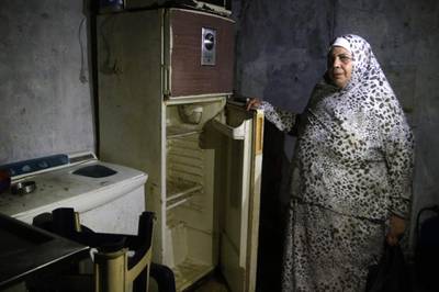 A Lebanese woman displays the content of her refrigerator at her apartment in the southern city of Sidon. AFP