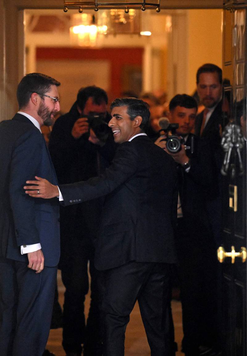 Mr Sunak is greeted by Cabinet Secretary and Head of the Civil Service Simon Case as he enters 10 Downing Street. AFP