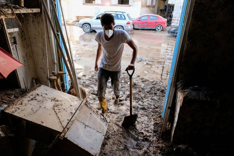A man clears mud from his pharmacy, which was affected by the fatal floods in Derna, Libya. Reuters