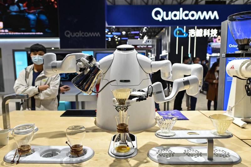 A robot prepares a coffee at a booth during the Mobile World Congress in Shanghai on February 23, 2021.  / AFP / Hector RETAMAL
