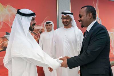 ABU DHABI, UNITED ARAB EMIRATES - March 18, 2019: HH Sheikh Khalifa bin Tahnoon bin Mohamed Al Nahyan, Director of the Martyrs' Families' Affairs Office of the Abu Dhabi Crown Prince Court (L) greets HE Abiy Ahmed, Prime Minister of Ethiopia (R), during the Special Olympics World Games Abu Dhabi 2019, at Abu Dhabi National Exhibition Centre (ADNEC). Seen with HH Sheikh Mohamed bin Zayed Al Nahyan, Crown Prince of Abu Dhabi and Deputy Supreme Commander of the UAE Armed Forces (C).

( Ryan Carter / Ministry of Presidential Affairs )?
---