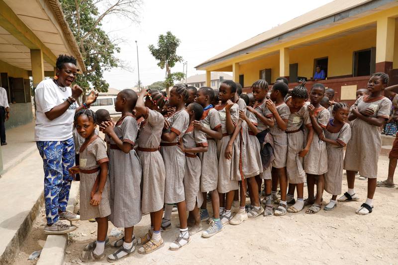 Jumoke Olowookere, founder of the Waste Museum, speaks to children at a school as she prepares them to repaint a playground made from used tyres in Ibadan, Nigeria, on February 22, 2022. Reuters