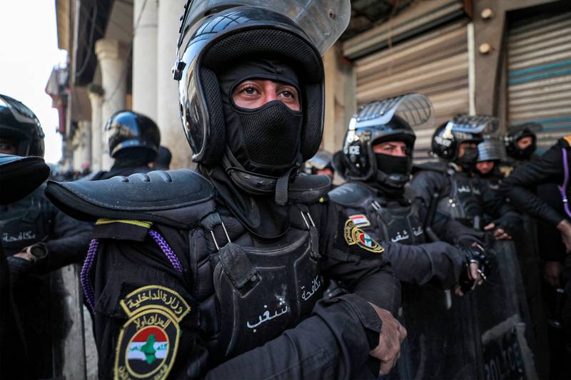 Iraqi security forces prepare to face protesters outside the Central Bank of Iraq. AFP