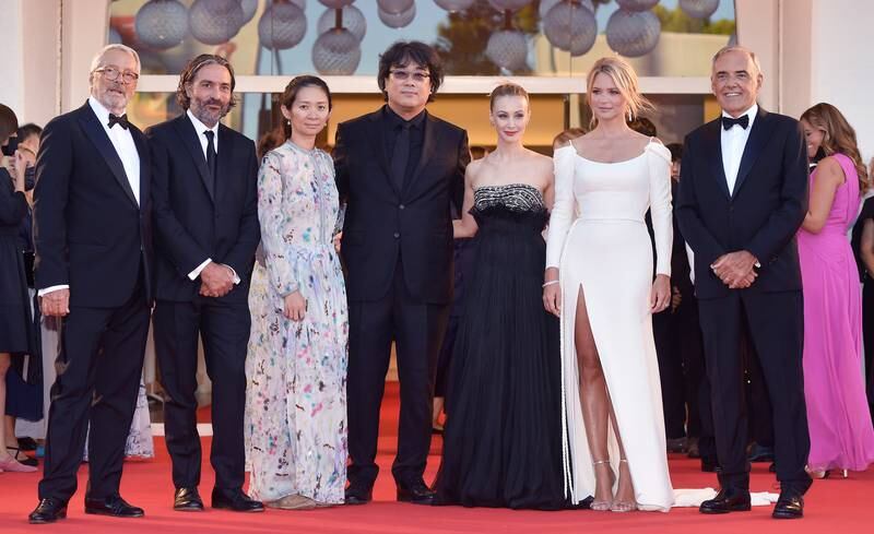 From left, Roberto Cicutto, president of the Venice Biennale, director Saverio Costanzo, director Chloe Zhao, director Bong Joon-ho, actress Sarah Gadon, actress Virginie Efira and festival director Alberto Barbera attend the red carpet for 'Madres Paralelas' during the 78th Venice International Film Festival on September 1, 2021. EPA