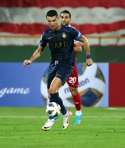 Cristiano Ronaldo of Al Nassr vies with Shahab Zahedi of Persepolis. EPA