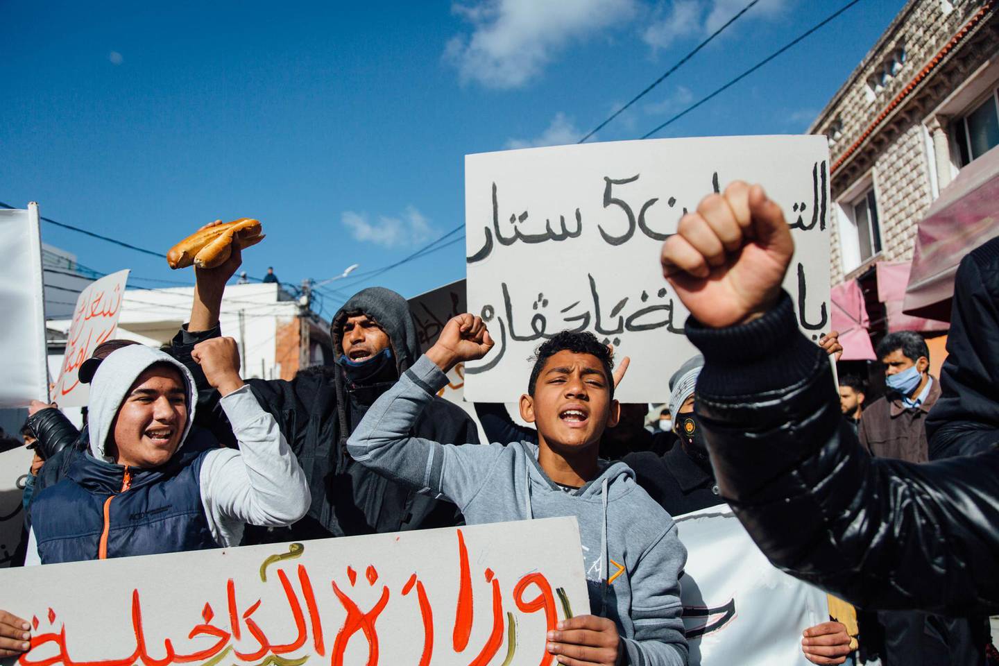 Protests in Ettadhaman, a working-class neighborhood in Tunis, in January, 2021. Several protesters brought loaves of bread as a symbol of the poverty and hunger they face. Erin Clare Brown for The National