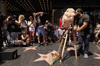 The Hollywood Chamber of Commerce honours  Newton-John with an arrangement of pink roses. AP