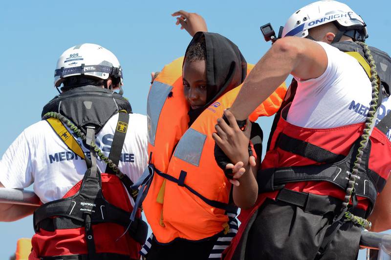 A woman is rescued by SOS Mediterranee organisation and Doctors Without Borders during a search and rescue (SAR) operation with the MV Aquarius rescue ship in the Mediterranean Sea, off the Libyan Coast, August 10, 2018. REUTERS/Guglielmo Mangiapane