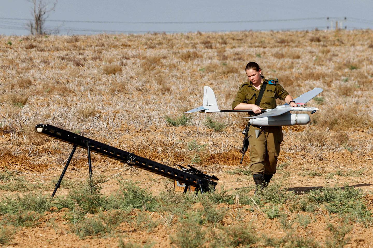 An Israeli soldier prepares an Elbit Systems Skylark I unmanned aerial vehicle (UAV or drone) for take-off near the border with the Gaza Strip in southern Israel in 2020. AFP