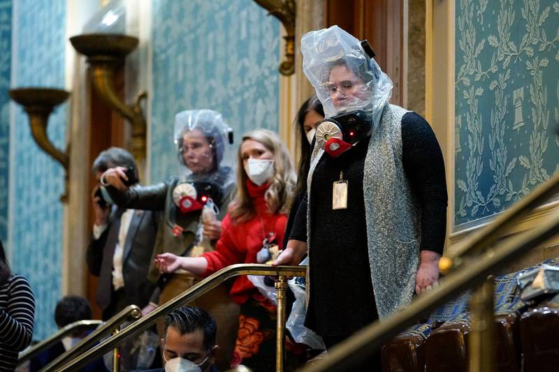People are seen in the House gallery as protesters try to break into the House Chamber at the U.S. Capitol on Wednesday, Jan. 6, 2021, in Washington. (AP Photo/Andrew Harnik)