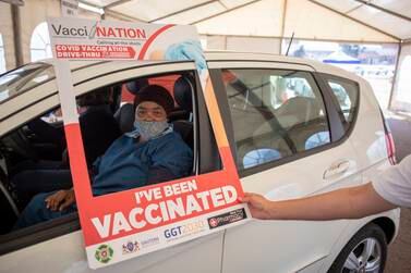 A person has her vaccine administered at a drive through Covid-19 coronavirus vaccination site at the Swartkops Raceway in Pretoria, South Africa, 18 August 2021.  South Africa has to date vaccinated 17 percent of the population and is aiming at starting vaccinations for over 18 year olds in the next weeks.   EPA / KIM LUDBROOK