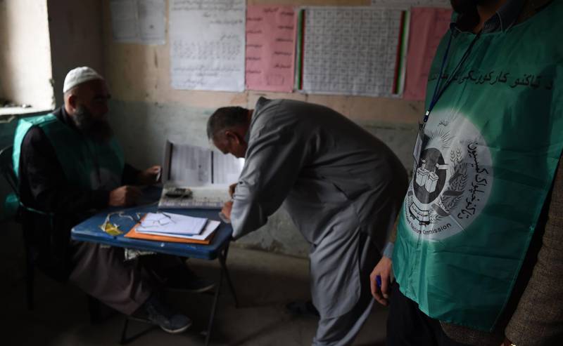 This photo taken on April 14, 2018 shows Afghan employees of the Independent Election Commission (IEC) registering a resident at a voter registration center for the upcoming parliamentary and district council elections in Kabul.
Afghanistan began registering voters across the war-torn country at the weekend, as it seeks to ensure long-delayed legislative elections in October are credible and fraud-free.
 / AFP PHOTO / Wakil KOHSAR