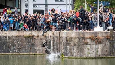 The statue of 17th century slave trader Edward Colston falls into the water after protesters pulled it down and pushed into the docks, during a protest against racial inequality in the aftermath of the death in Minneapolis police custody of George Floyd, in Bristol, Britain, June 7, 2020. Picture taken June 7, 2020. Keir Gravil via REUTERS       THIS IMAGE HAS BEEN SUPPLIED BY A THIRD PARTY. MANDATORY CREDIT. THIS IMAGE WAS PROCESSED BY REUTERS TO ENHANCE QUALITY, AN UNPROCESSED VERSION HAS BEEN PROVIDED SEPARATELY.