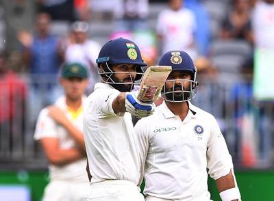 India's captain Virat Kohli raises his bat after scoring his half century on day two of the second test match between Australia and India at Perth Stadium in Perth, Australia, December 15, 2018. AAP/Dave Hunt/via REUTERS  ATTENTION EDITORS - THIS IMAGE WAS PROVIDED BY A THIRD PARTY. NO RESALES. NO ARCHIVE. AUSTRALIA OUT. NEW ZEALAND OUT.