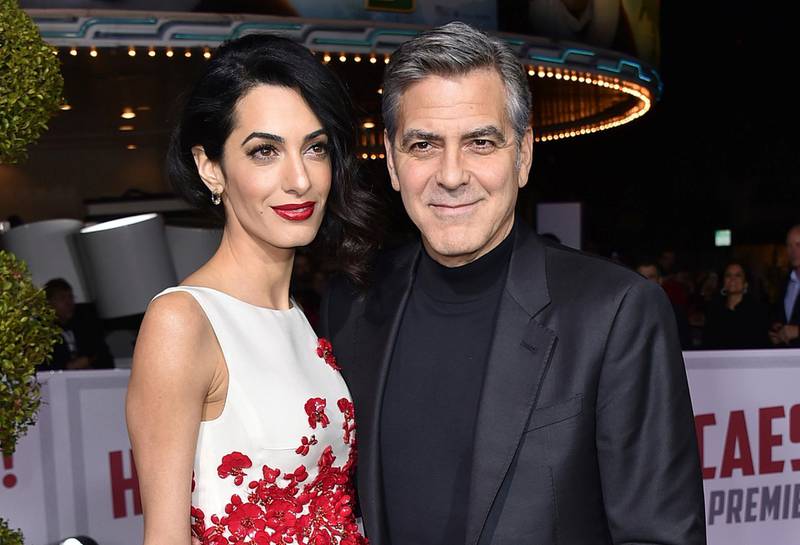 FILE - In this Feb. 1, 2016 file photo, Amal Clooney, left, and George Clooney arrive at the world premiere of "Hail, Caesar!" in Los Angeles. Clooneyâ€™s foundation is planning to open seven public schools for Syrian refugee children. The Clooney Foundation for Justice announced a new partnership Monday, July 31, 2017, with Google, HP and UNICEF to provide education for more than 3,000 refugee children in Lebanon. (Photo by Jordan Strauss/Invision/AP, File)