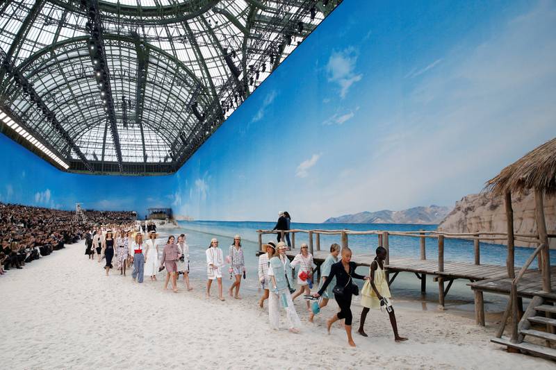Models present creations by German designer Karl Lagerfeld as part of his Spring/Summer 2019 women's ready-to-wear collection show for fashion house Chanel at the Grand Palais transformed as a beach scene during Paris Fashion Week in Paris, France, October 2, 2018. REUTERS/Stephane Mahe